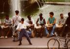 Trocadero Plaza, Paris, august 1995. Rolleiflex SL35 + TeleTessar 200mm, Kodak Gold 100. Tele shot of the djembe session. This Algerian (?) character was really getting into it! Note the yellow sticker on his shirt bearing the slogan 