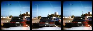 Gulf road, Kuwait. January 1997. Stereo Realist, Kodak Gold 400. Great view of Kuwaiti headgear in the Chevy in front waiting at a red light. Kuwait towers is just up ahead. The red splotch is yet another infamous Realist lightleak!