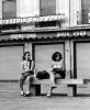 Granada, june 1999. Rolleiflex 3.5 B, Ilford XP2. I spotted these two Miss Universe candidates while relaxing in a plaza after spending the entire day wandering about the Alhambra. They popped up in my TLR's viewfinder as I was scanning my surroundings just for fun. Something caught their attention, they looked up, and I snapped. They didn't have clue, simply because I didn't have to raise the camera to my eyes, but rather casually operated it in my lap. This a good example of the merits of a waistlevel finder. Though the camera itself is conspicuous and bulky, it's actual *operation* isn't -- the quiet leaf shutter helps too. Looking at the photograph now, maybe I *should* have taken a closer look before snapping...